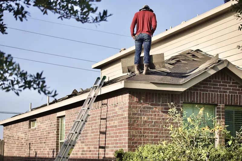 Professional roofer working on a residential roof in Rugby
